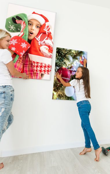 woman holding photo canvas on the background of a interior.